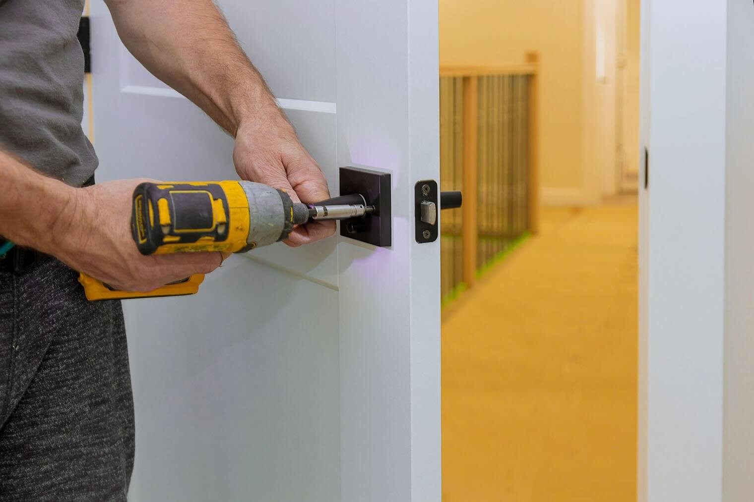 handyman-installing-the-door-lock-in-the-room-with-2022-08-01-04-00-05-utc-min.jpg